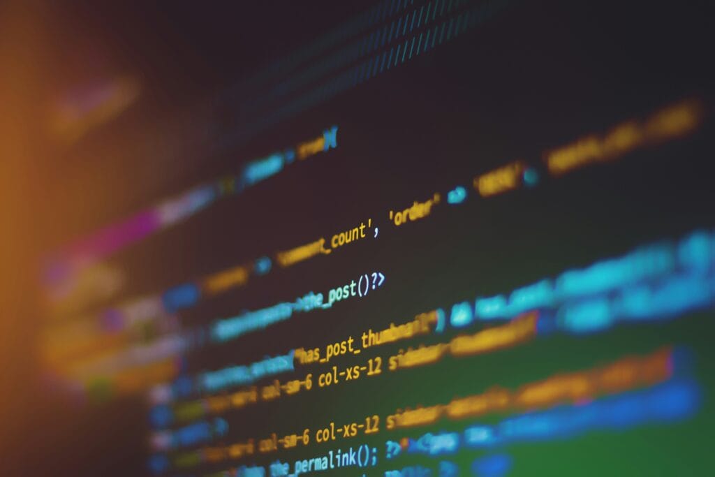 Colorful lines of code on a dark monitor, illustrating how an AI coding agent can be hijacked through a fake error report