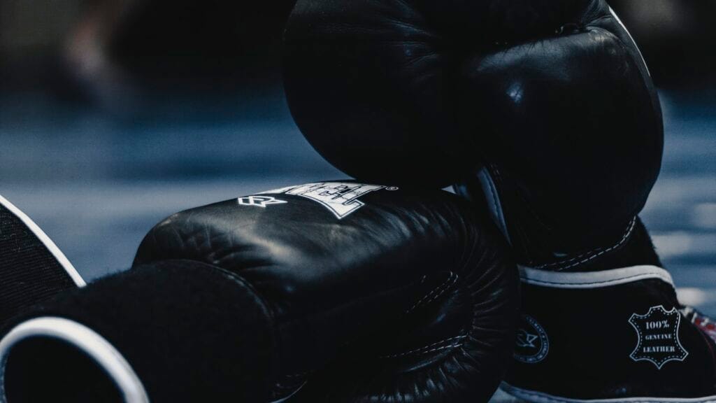 Two red boxing gloves representing the Apple versus OpenAI trade-secret lawsuit