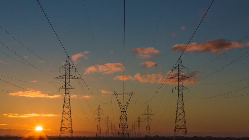 High-voltage electricity pylons and power lines against the sky