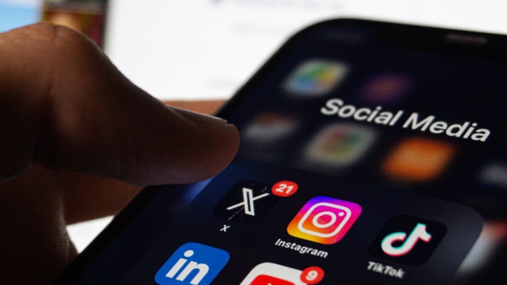 Phone with social media chaos representing AI discourse memes