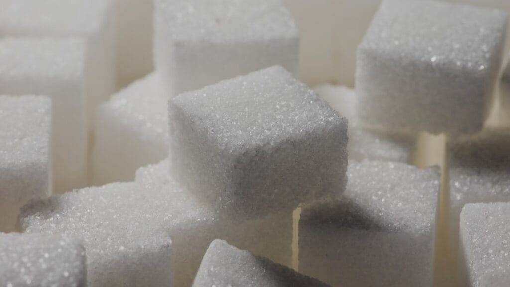 White sugar cubes stacked on a surface