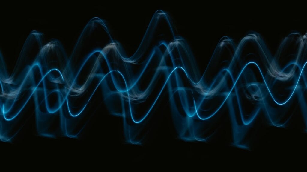 Abstract blue sound-wave visualisation on a dark background