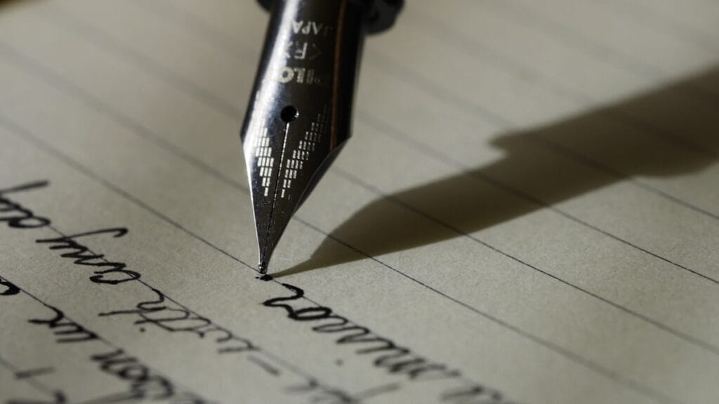 Fountain pen resting on lined paper, illustrating the draft-then-refine AI pattern