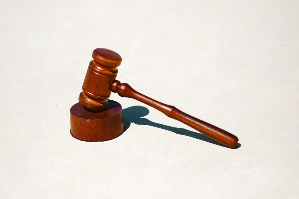 A judge's gavel on a white surface