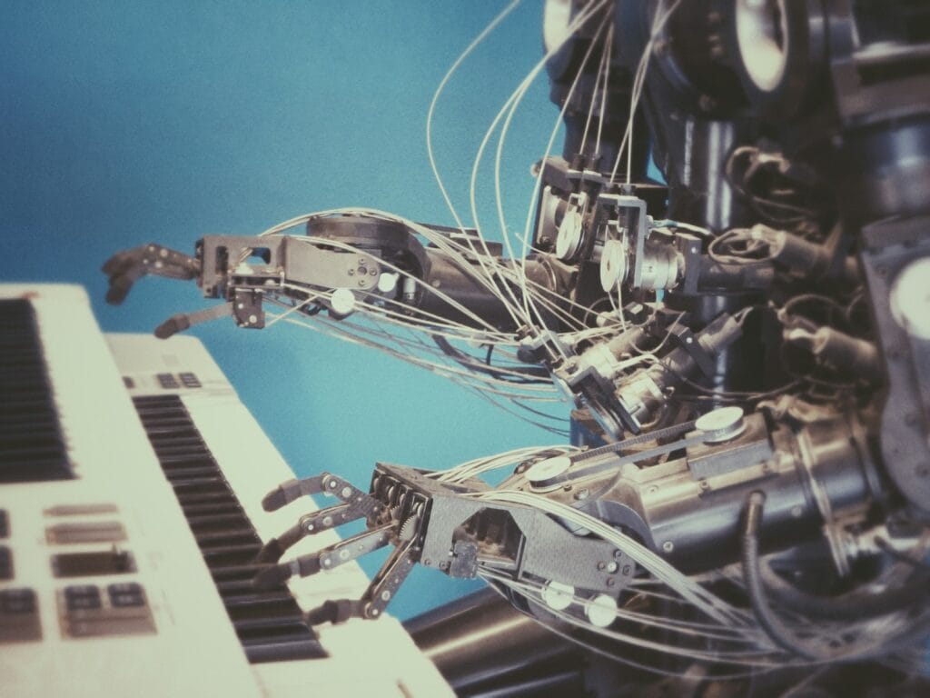 A white robot hand playing a piano keyboard